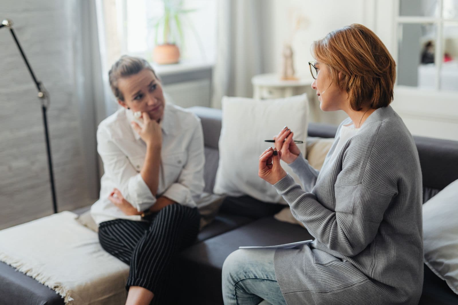 Therapist and client in conversation on a couch